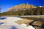 Stock photo of Castle Mountain and the Bow River under blue sky during late winter along Highway 93, Banff National Park, Canadian Rocky Mountains, Alberta, Canada. Banff National Park forms part of the Canadian Rocky Mountain Parks UNESCO World Heritage 