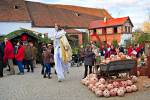 Stock photo of a man on stilts dressed as a fairy, looking for Christmas gifts and interacting with the crowd at the Christmas Markets at Hexenagger Castle, Hexenagger, Bavaria, Germany, Europe.