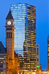 Stock photo of the Clock Tower of the Old City Hall and a modern building in downtown Toronto at dusk Ontario Canada.