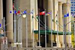 Stock photo of flag poles bearing the provincial and territorial flags of Canada outside the Government Conference Centre in Ottawa.