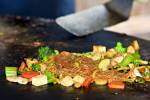 Stock photo of the food on the large grill as it is prepared at the Mongolie Grill World Famous Stirfry Restaurant in Whistler Village, British Columbia, Canada. Property Released.