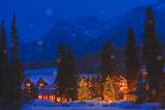 Stock photo of a winter night scene of the Post Hotel located on the snow covered banks of the Pipestone River, Lake Louise, Banff National Park, Canadian Rocky Mountains, Alberta, Canada.
