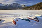 Stock photo of snow covered dinghies and canoes on the shores of Pyramid Lake near the town of Jasper in Jasper National Park in the Canadian Rocky Mountains in Alberta, Canada.