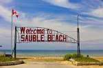 Stock photo of the Sauble Beach welcome sign on the shores of Lake Huron, Ontario, Canada.