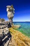 Stock photo of the rocky shoreline and the Sea Stack of Flowerpot Island in the Fathom Five National Marine Park, Lake Huron, Ontario, Canada.