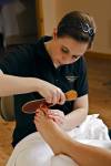 Stock photo of a therapist giving a relaxing pedicure treatment at the Black Bear Resort & Spa, Port McNeill, North Vancouver Island, Vancouver, Canada.