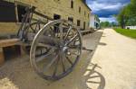 Stock photo of two wheeled wagon outside the Furloft/Saleshop (built in 1831) at Lower Fort Garry - a National Historic Site, Selkirk, Manitoba, Canada.