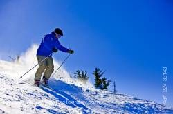 Skier Descending From Upper Slopes Of Whistler Mountain In Whistler British Columbia Canada