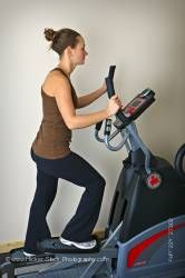 Woman working out elliptical trainer