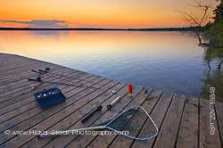 Sunset fishing equipment wharf Lake Audy Riding Mountain National Park Manitoba Canada