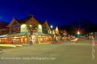 Stock photo of a nighttime street scene in winter, looking north from the corner of Banff Avenue and Caribou Street towards Cascade Mountain at night in the Town of Banff, Banff National Park, Canadian Rocky Mountains, Alberta, Canada.