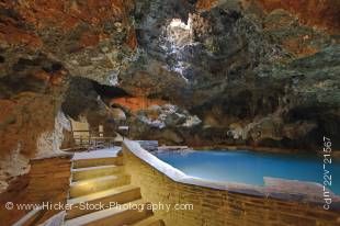 Stock photo of the relaxing geothermal hot springs pool and a concrete walkway in the Cave and Basin National Historic Site, Sulphur Mountain, Banff National Park, Alberta, Canada.