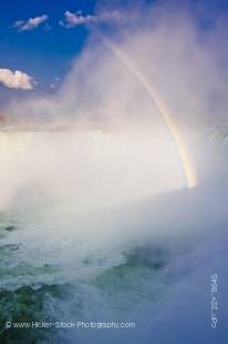 Stock photo of Horseshoe Falls with a rainbow in the misty air above the Niagara River in Niagara Falls, Ontario, Canada.