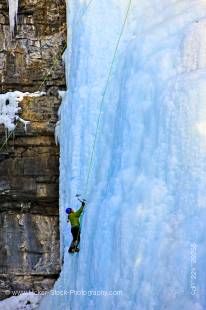 Stock photo of an ice climber on the Upper Falls of the Johnston Creek during winter in Johnston Canyon, Banff National Park, Canadian Rocky Mountains, Alberta, Canada. 