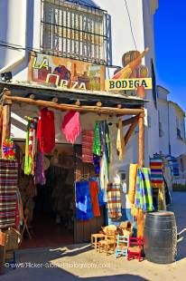 Stock photo of Hand woven blankets and clothing outside La Orza Bodega and gift store in the town of Trevelez, Las Alpujarras, Sierra Nevada, Parque Natural de Sierra Nevada, Province of Granada, Andalusia (Andalucia), Spain, Europe.
