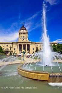 Stock photo of the Legislative Building and fountain against a deep blue sky in the Manitoba Plaza in the City of Winnipeg, Manitoba, Canada.