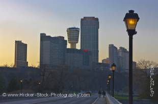 Stock photo of the City of Niagara Falls skyline as seen from along the Niagara Parkway beside the Niagara River at sunset in Ontario, Canada.