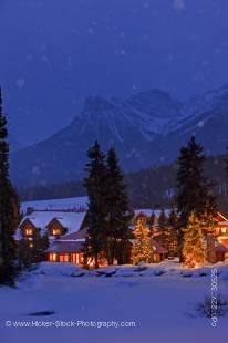 Stock photo of a winter night scene at the Post Hotel located on the snow covered banks of the Pipestone River, Lake Louise, Banff National Park, Canadian Rocky Mountains, Alberta, Canada.