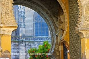 Stock photo of looking through the archway of Puerta del Perdon (Door of Forgiveness), Seville Cathedral and La Giralda (bell tower/minaret), a UNESCO World Heritage Site, Santa Cruz District, City of Sevilla (Seville), Province of Sevilla, Andalusia (And