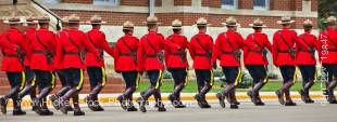 Panoramic stock photo of men and women marching in sync in the Sargeant Major's Parade and Graduation ceremony at the RCMP Academy, City of Regina, Saskatchewan, Canada.