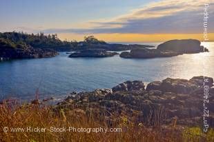 Stock photo of the rocky outcrops of South Beach in Pacific Rim National Park, Long Beach Unit, Clayoquot Sound UNESCO Biosphere Reserve, West Coast, Pacific Ocean, Vancouver Island, British Columbia, Canada. The blue sky is half covered by clouds that ha