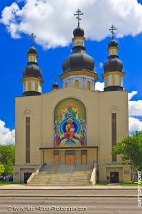 Stock photo of the facade of the Holy Trinity Ukrainian Orthodox Metropolitan Cathedral in the City of Winnipeg, Manitoba, Canada. A gorgeous bright blue sky with a few huge fluffy white clouds make a beautiful backdrop for this very attractive building w