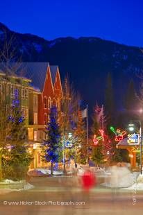 Stock photo of decorative lighting and pedestrian activity along the Village Stroll at dusk in winter, Whistler Village, British Columbia, Canada.