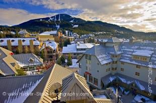 Stock photo of the view of Whistler Mountain against a blue sky with white clouds as seen from the Pan Pacific Hotel, Whistler Village, British Columbia, Canada.