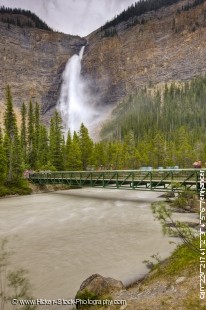 Stock photo of the bridge along the trail to the beautiful cascading waterfall Takakkaw Falls waterfall along the Yoho River in Yoho National Park, British Columbia, Canada.