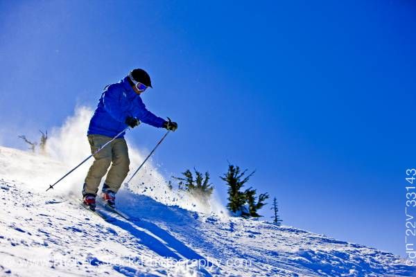 Stock photo of Skier Descending From Upper Slopes Of Whistler Mountain In Whistler British Columbia Canada