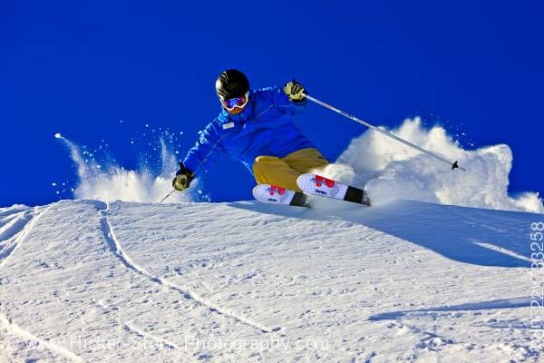 Stock photo of Action Downhill Skier Whistler Mountain British Columbia Canada Blue Sky