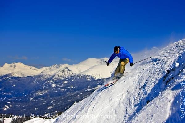 Stock photo of Skier Steep Slope Whistler Mountain Blue Sky British Columbia Canada