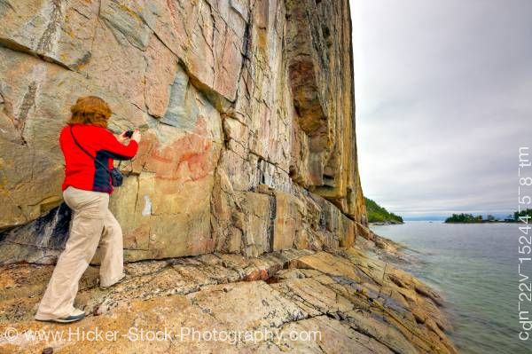 Stock photo of Woman on Rock Ledge along the Agawa Rock Pictographs Trail in Lake Superior Provincial Park Ontario